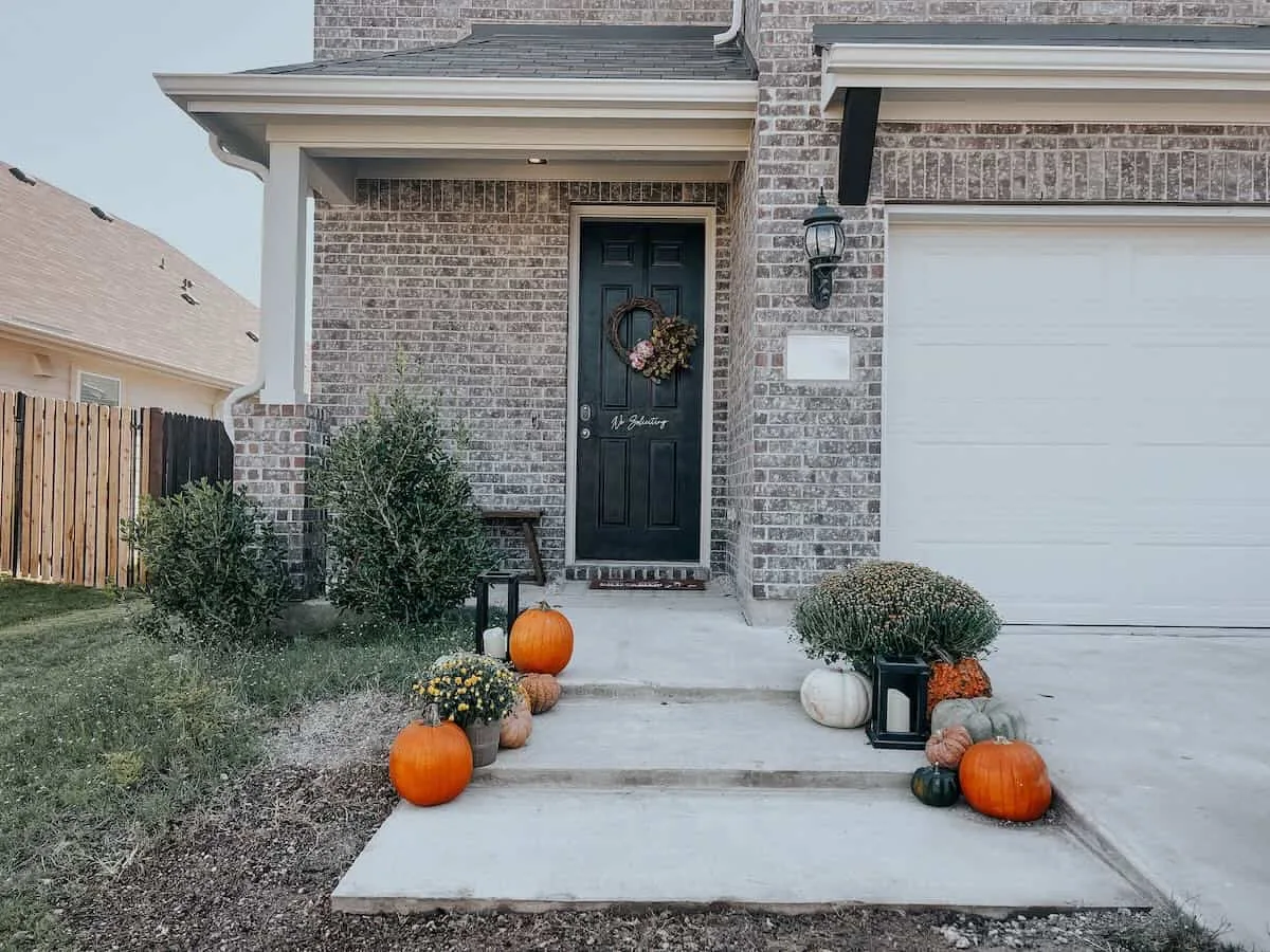 New concrete front steps and landing at the entry of a brick house, concrete work